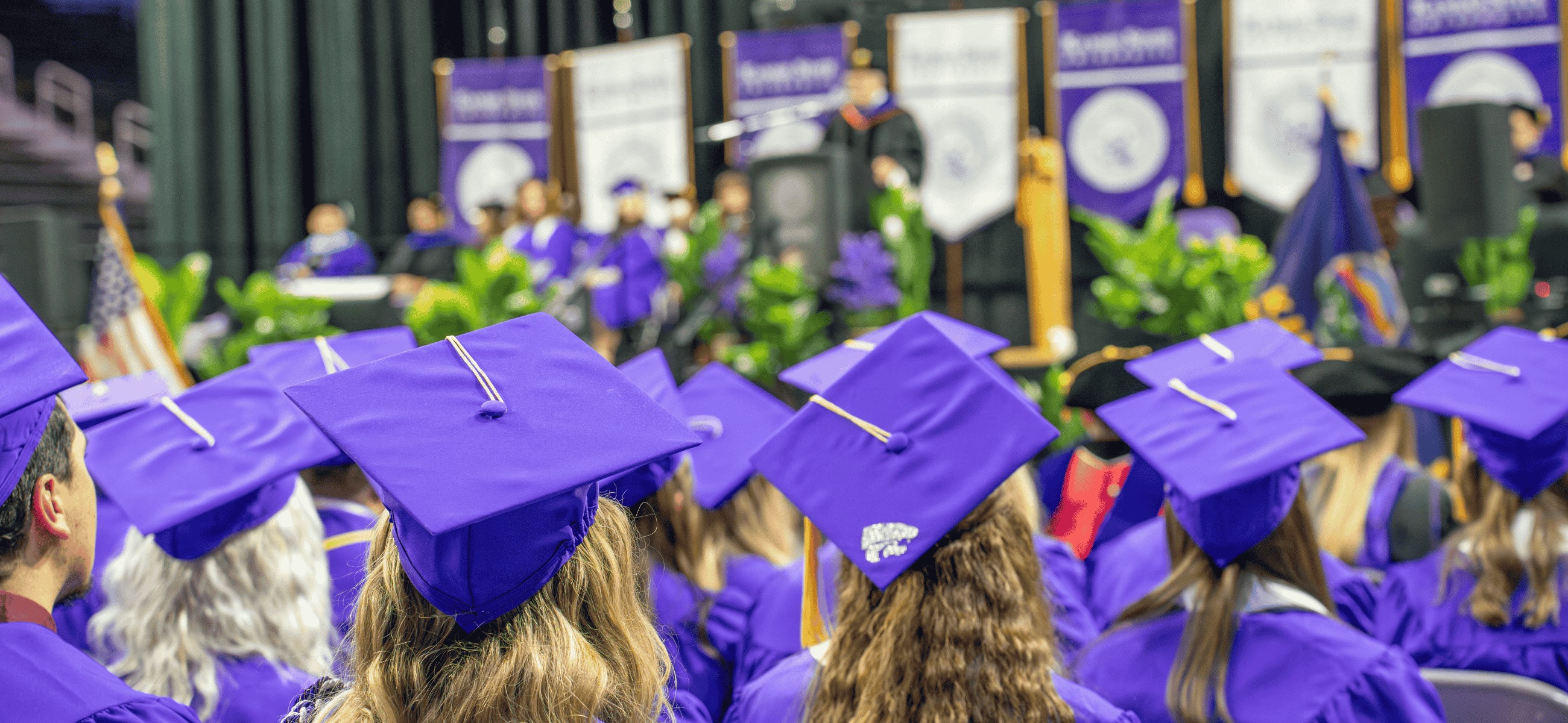 A photo from graduation showing students from behind